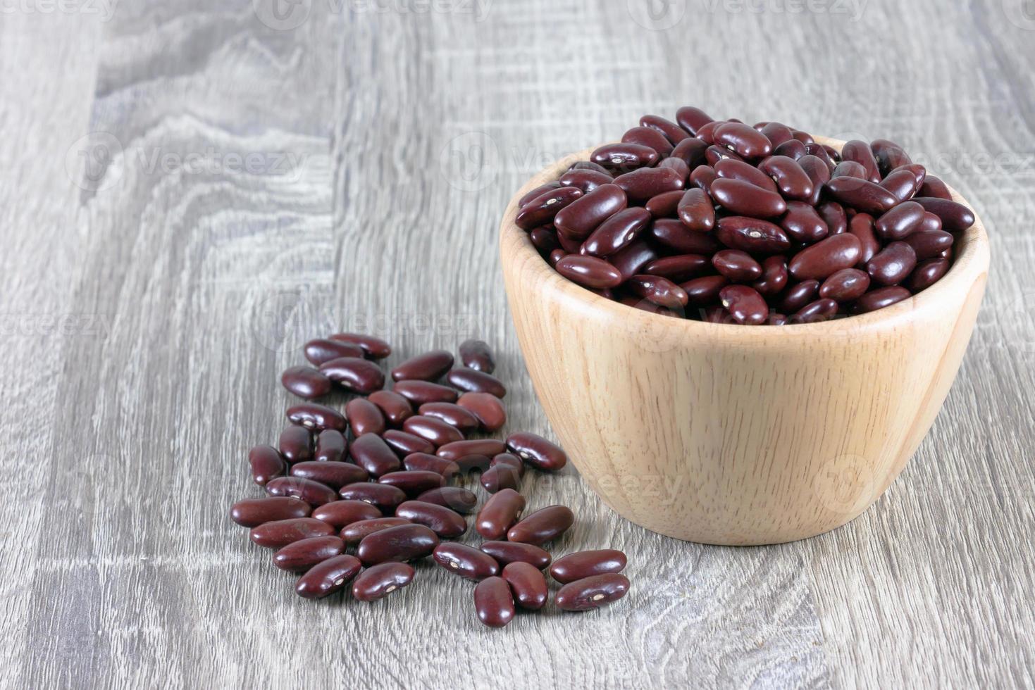 Red bean in wood bowl placed on the wooden table photo