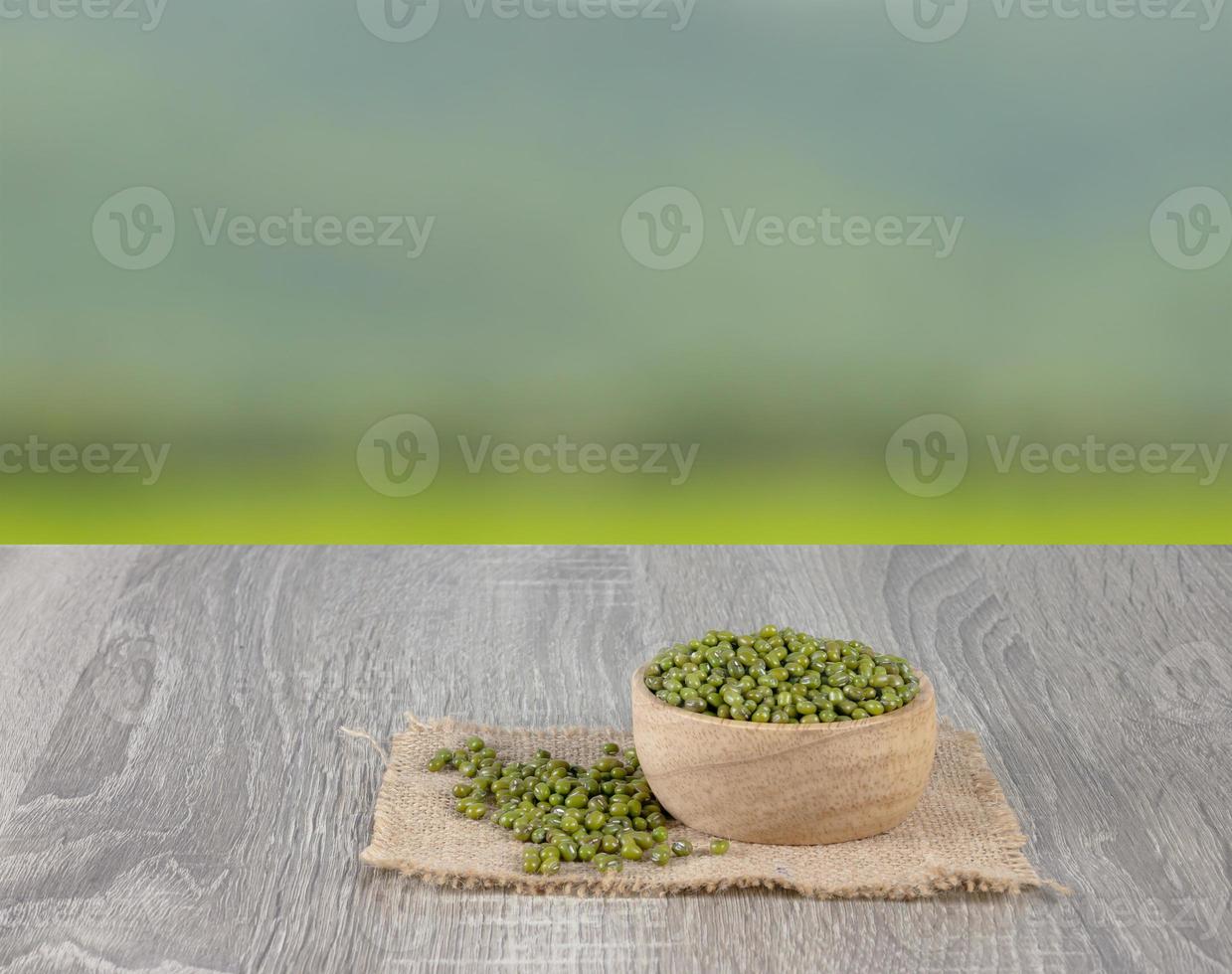 Green beans overflow wooden bowls and pile on the woven sack with green nature photo
