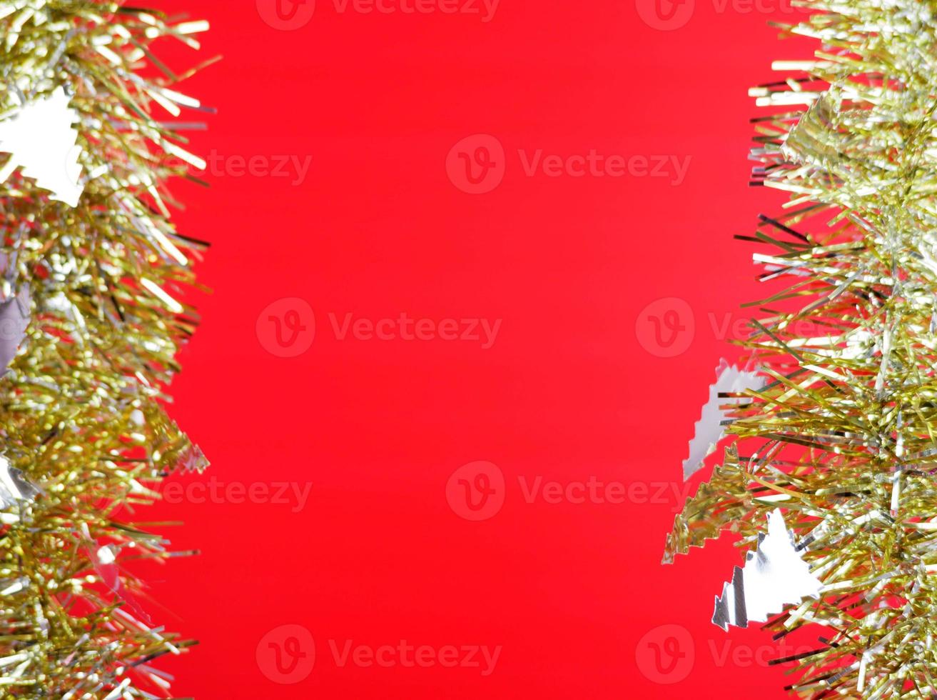 Silver christmas tree and gold ribbon on red background photo
