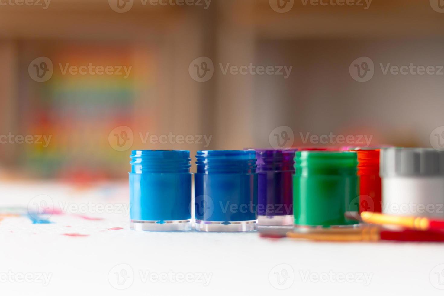 Bottles of poster color and brush photo