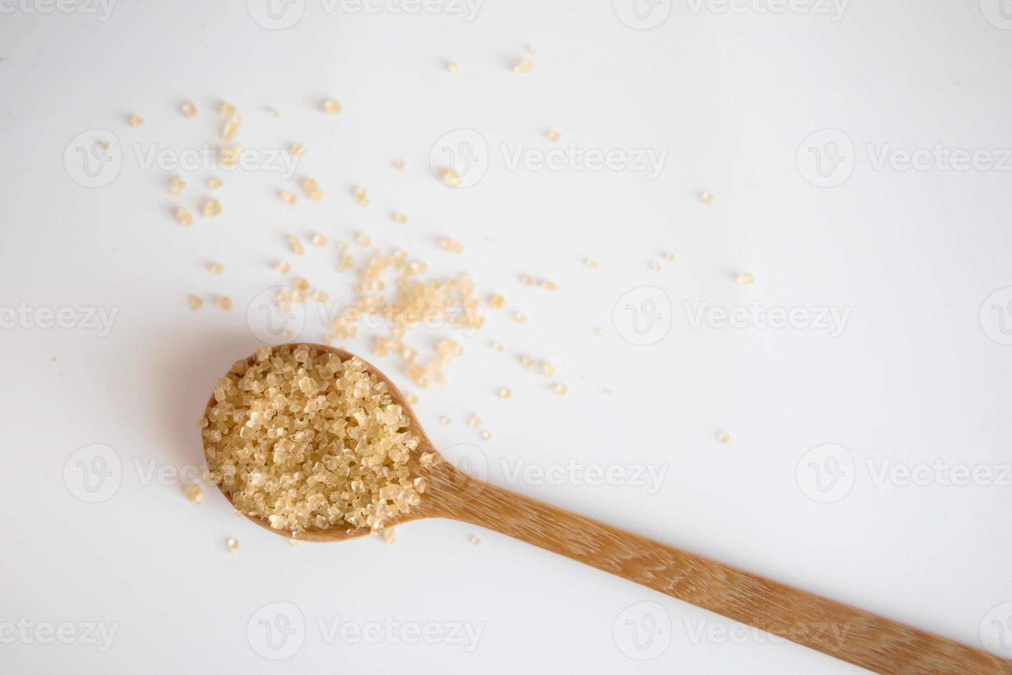 Brown sugar in a wooden spoon photo