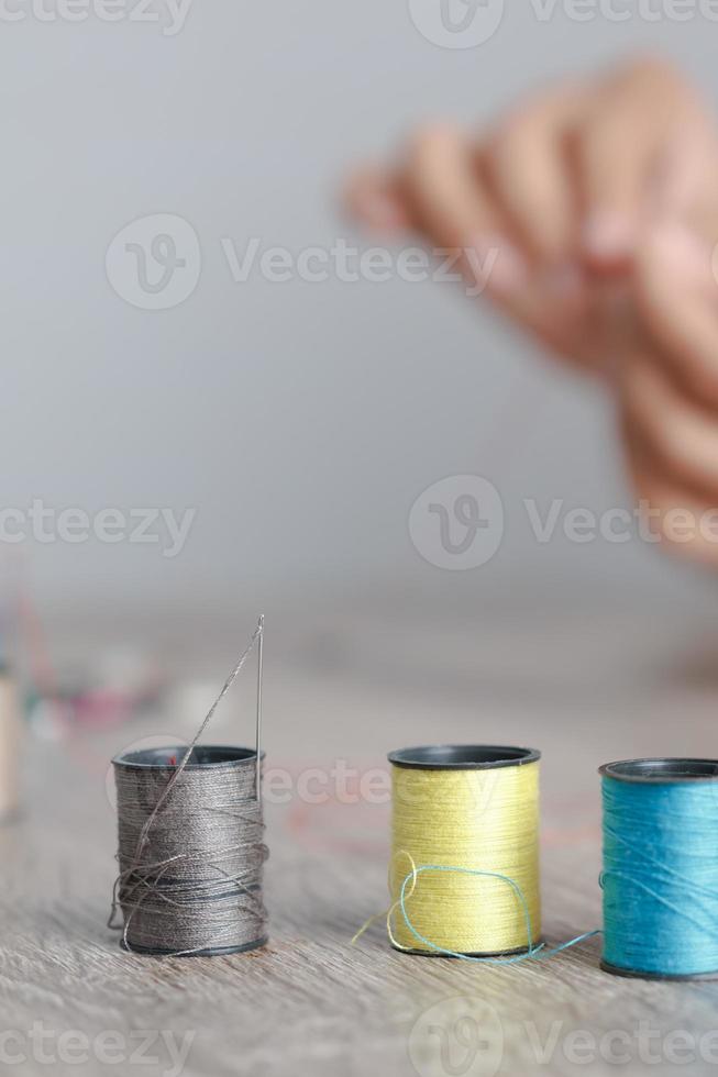 Close up the thread that was placed on the table to sew photo