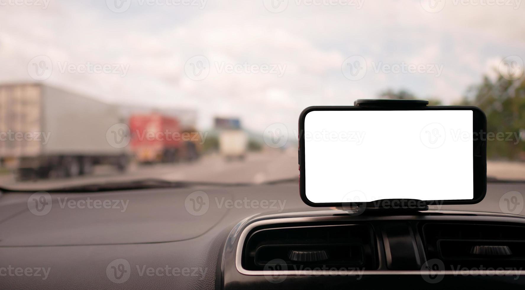 smartphone on the front handle of the car with white screen photo