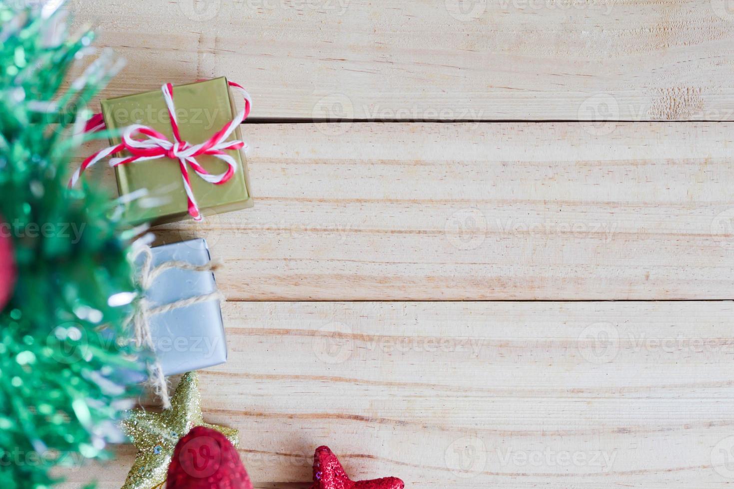 Christmas tree with gift boxes and star on the wooden table photo