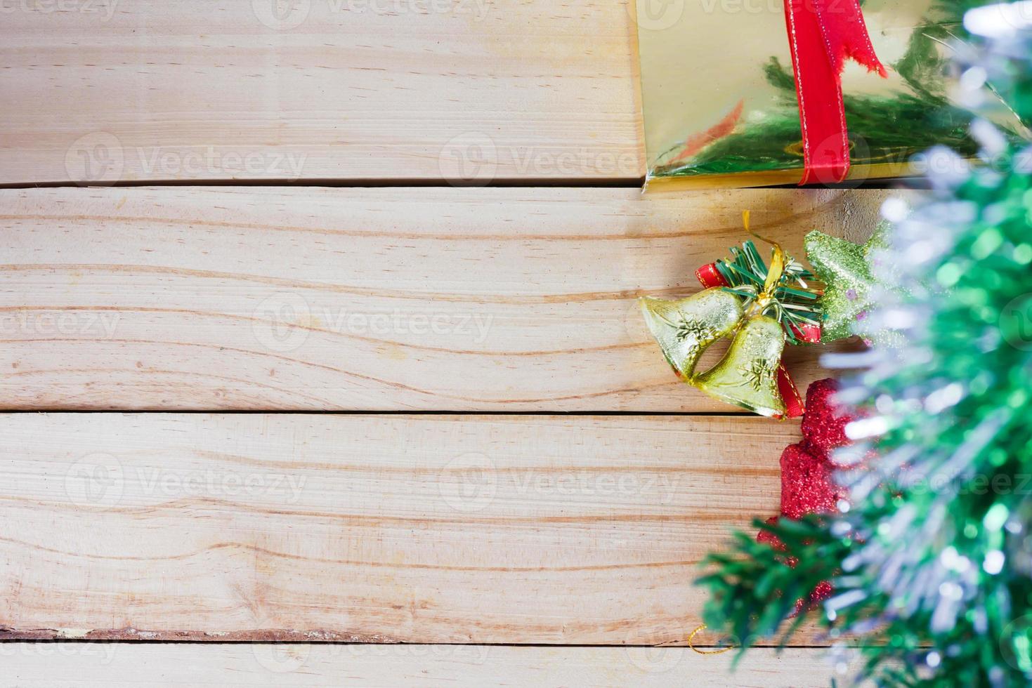 Christmas tree and golden bells with star on the wooden background photo