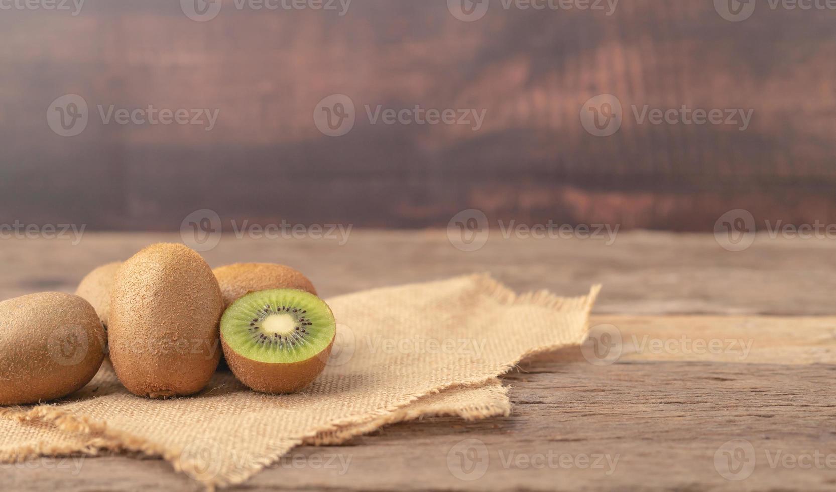 Kiwi fruits or Actinidia chinensis and a half on the sack photo