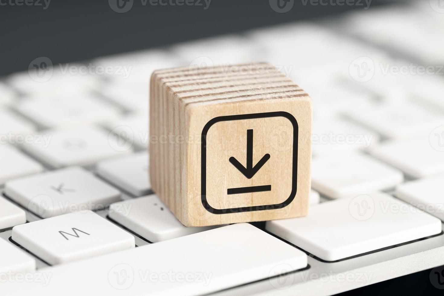 Download icon on wooden block on computer keyboard. Downloading data storage photo
