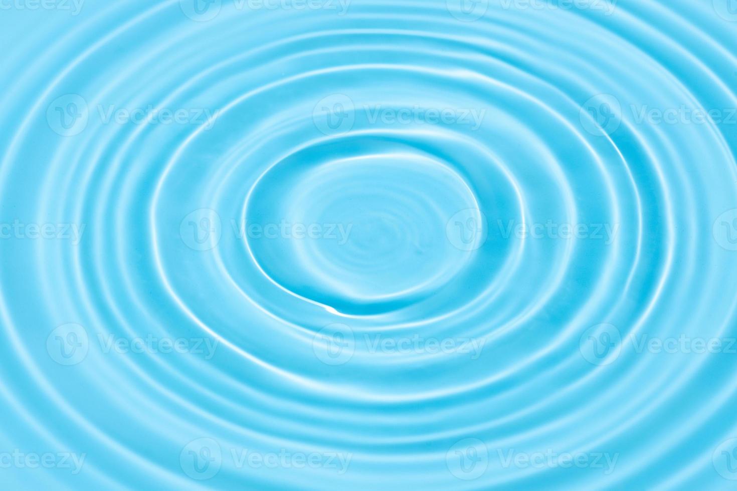 Blue Water background texture with Drop circles on water surface photo