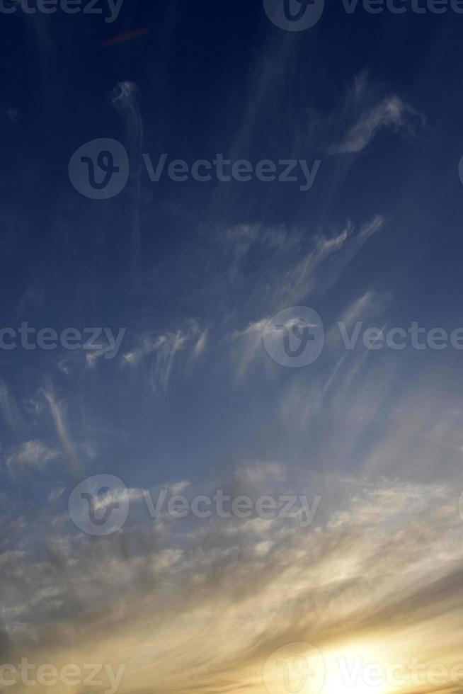 Evening sunset sky with blue and yellow clouds photo