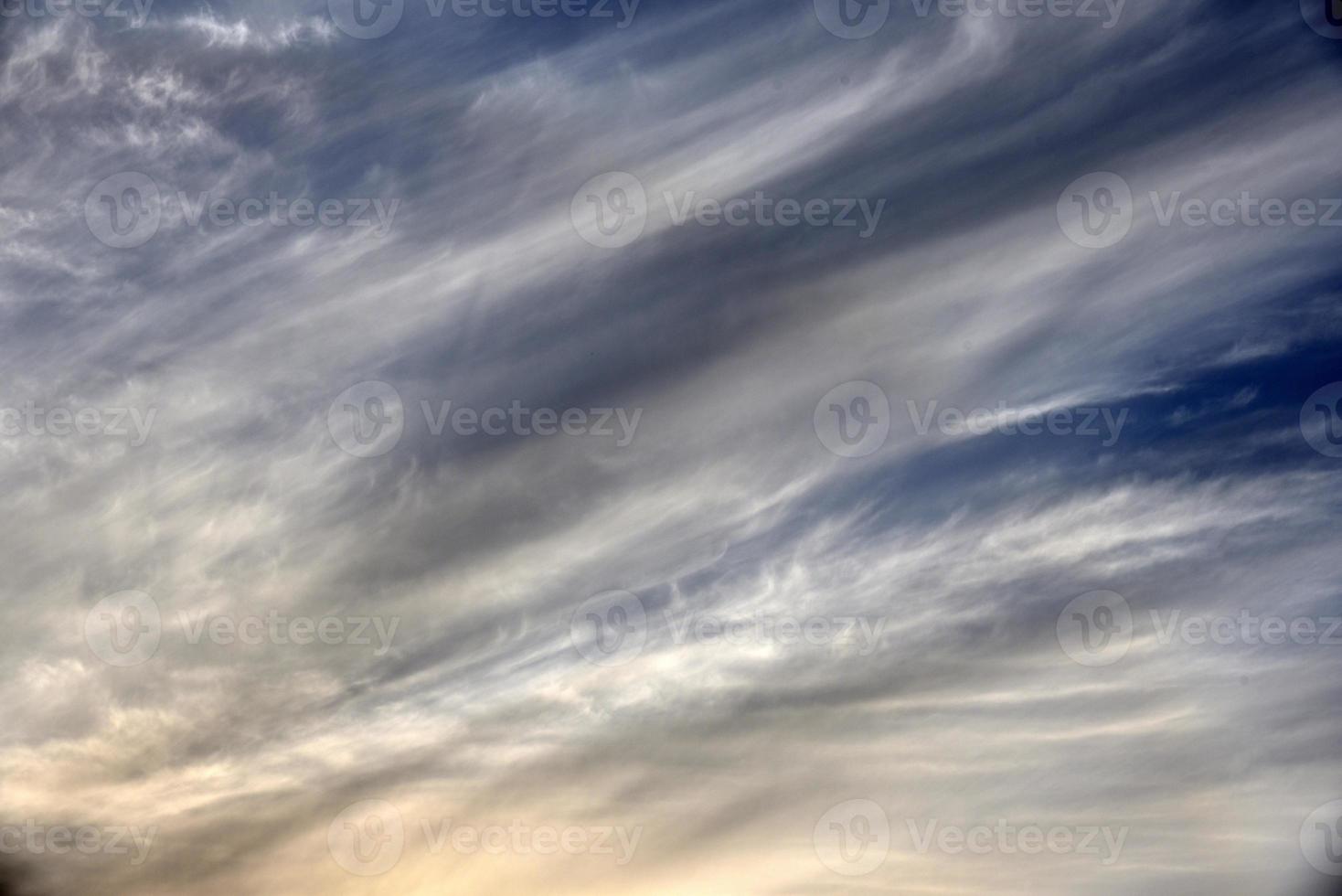 Evening sunset sky with blue and yellow clouds photo