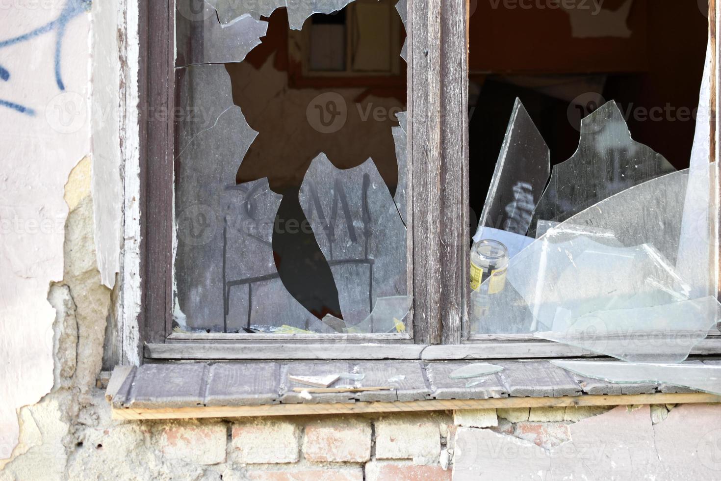 The window in the house is broken glass hooliganism. photo