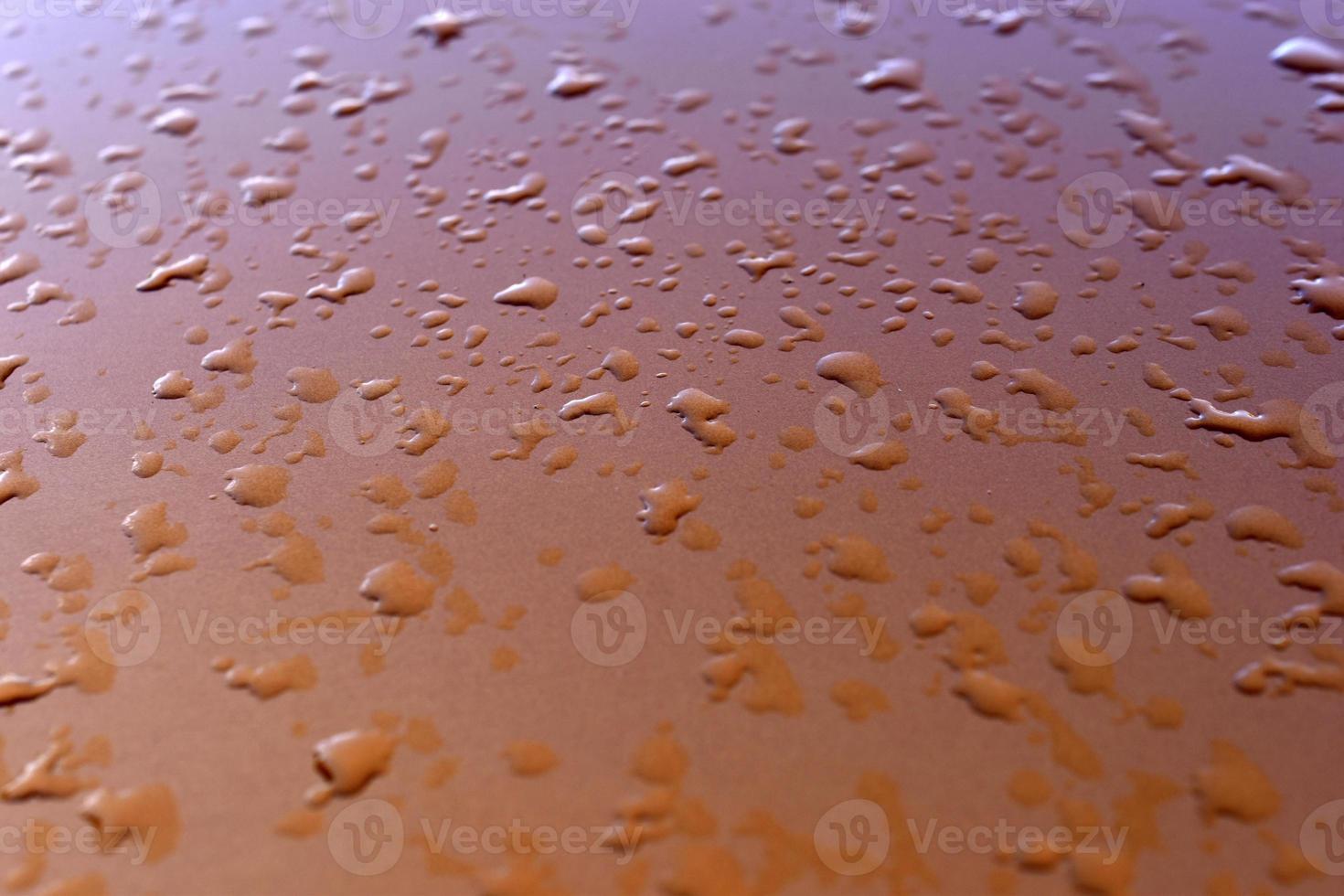 Water drops after rain on an orange background photo