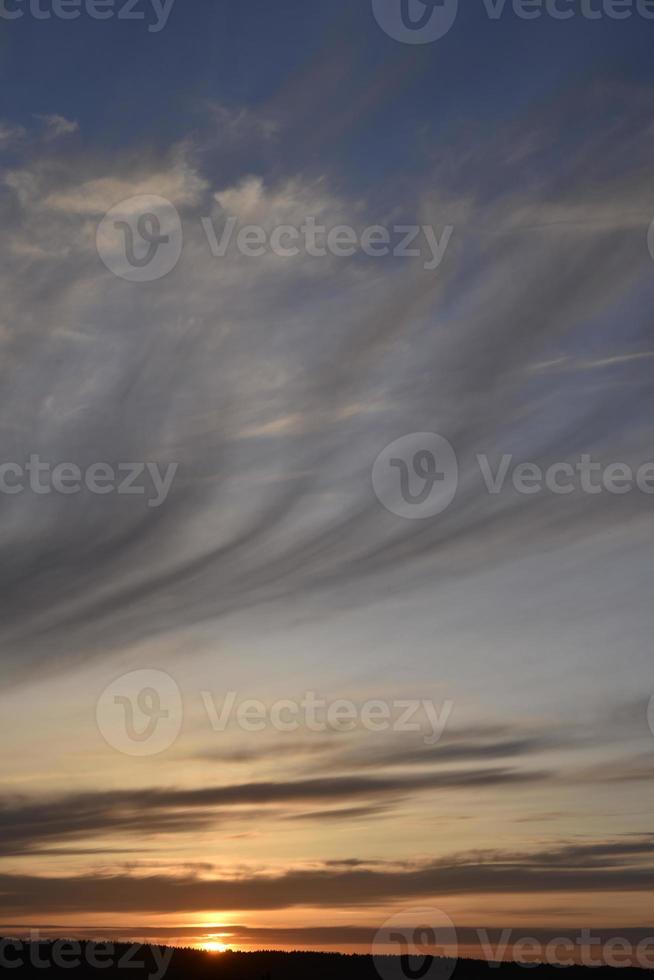 Evening sunset and sun with clouds and horizon photo