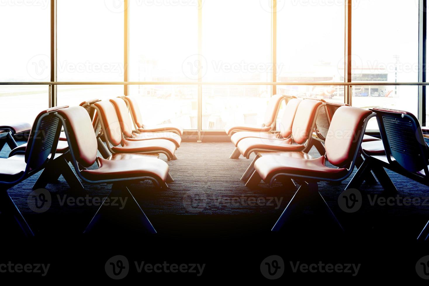 Departure lounge with empty chairs in the terminal of airport, waiting area photo