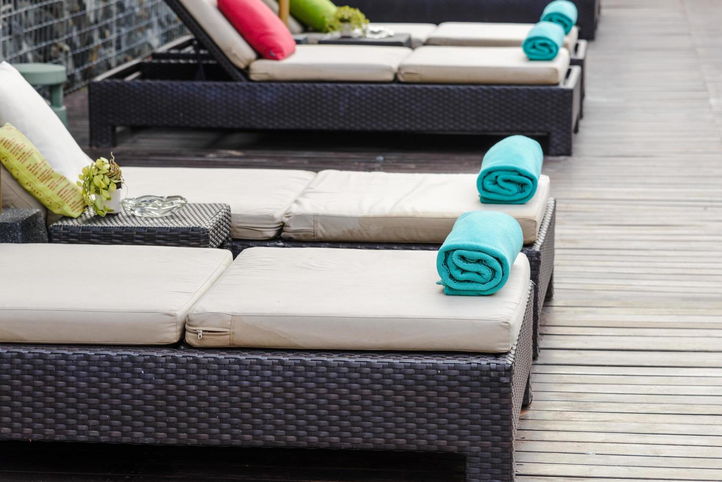 New towels on a sun-bed near a swimming pool. photo