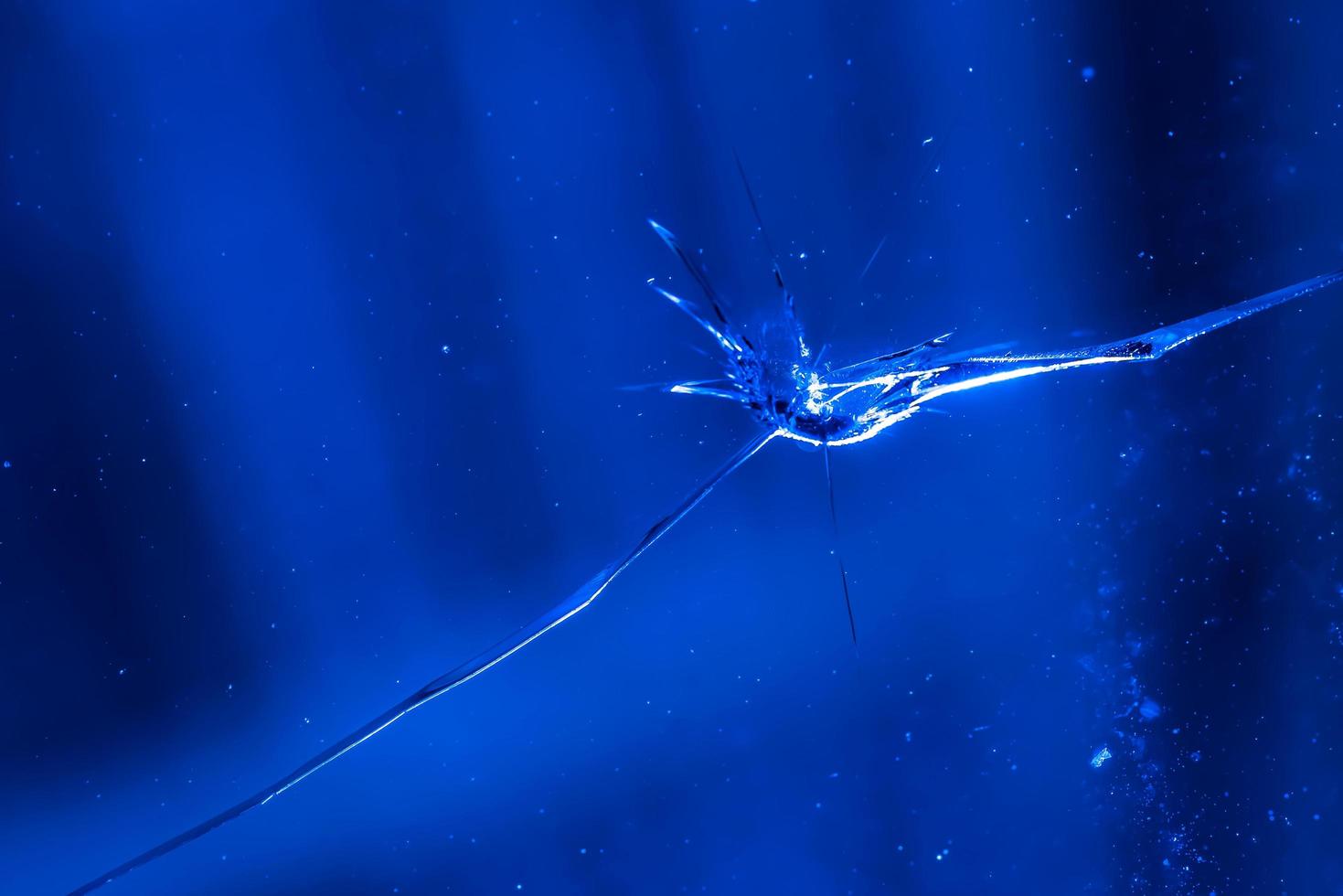 cracks on glass, Texture of broken glass. the glass was broken by a bullet. photo