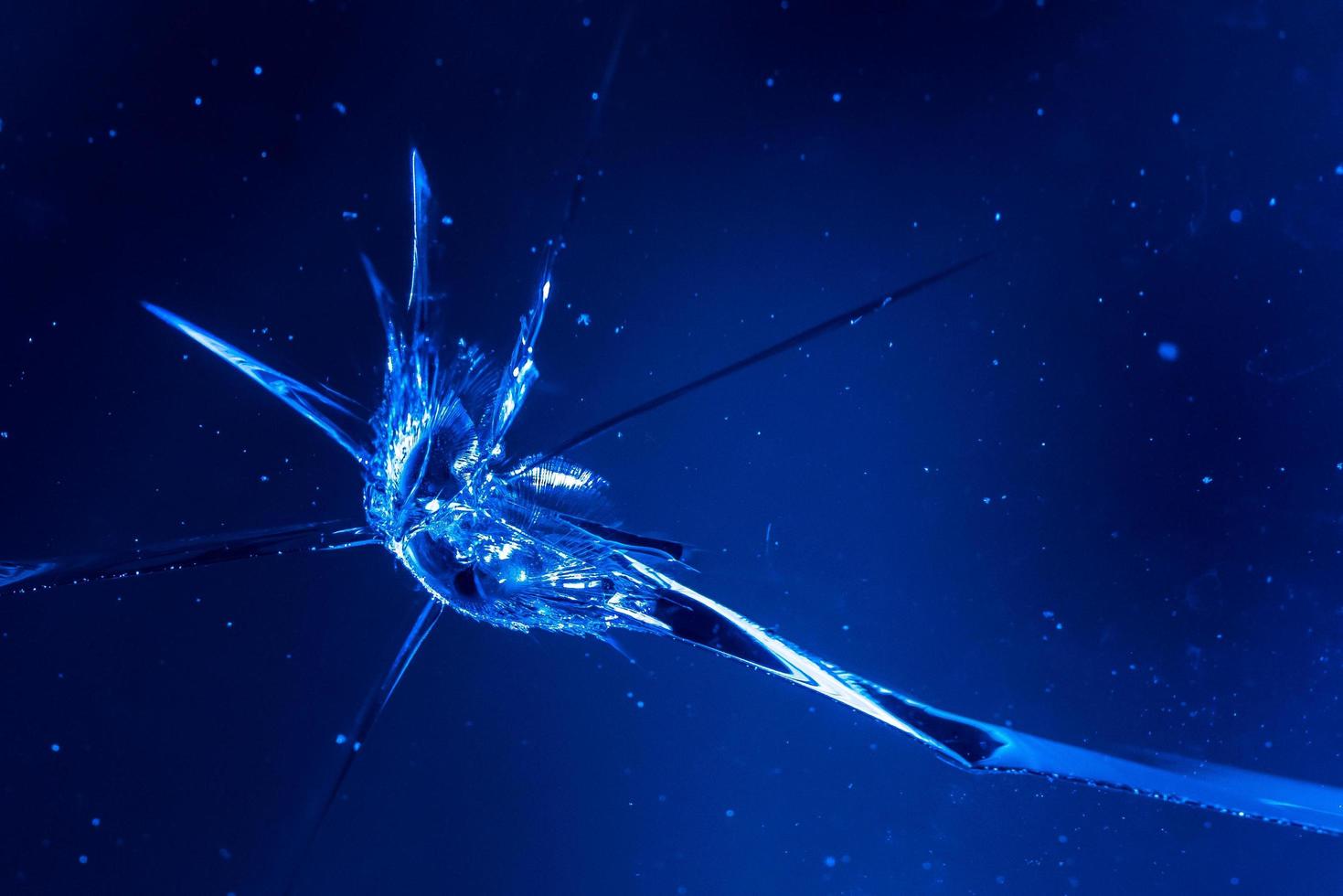 cracks on glass, Texture of broken glass. the glass was broken by a bullet. photo