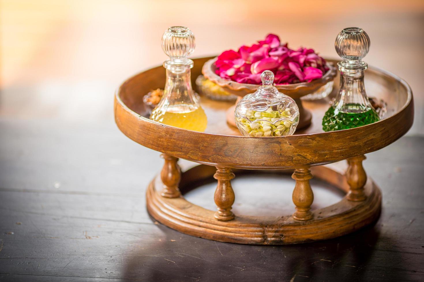 Thai traditional perfume Made from roses and jasmine in crystal glass bottle,soft focus. photo