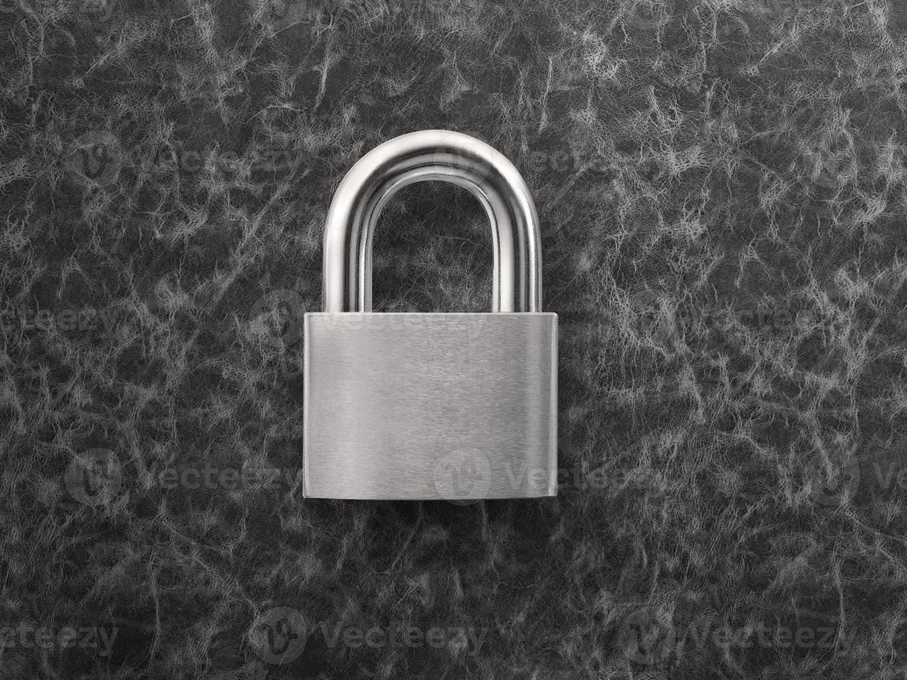 silver closed lock on a black leather background photo