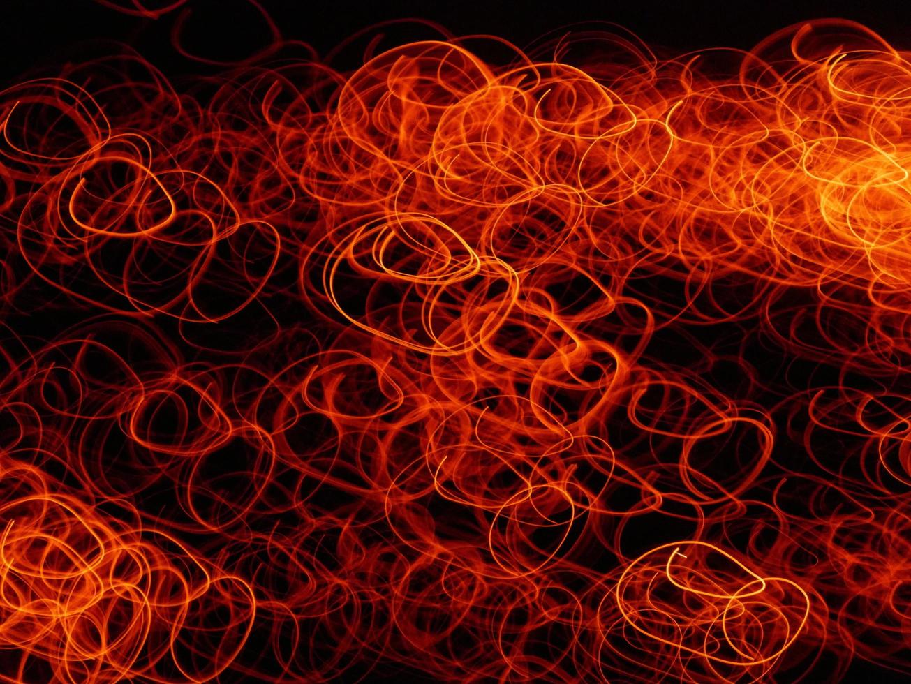 Fire flames with sparks on a black background.By shooting at high speed. photo