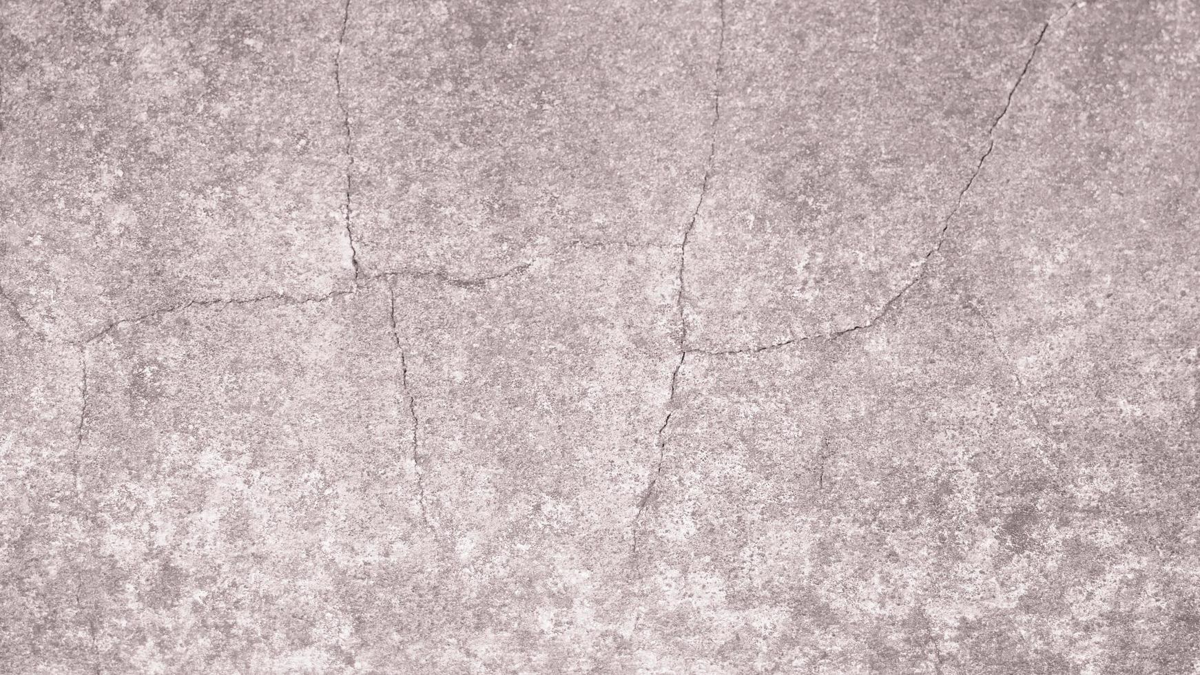 The old cement wall was weathered, the surface was scratched, the surface was scratched and damaged. For a mysterious retro-conservative background. photo