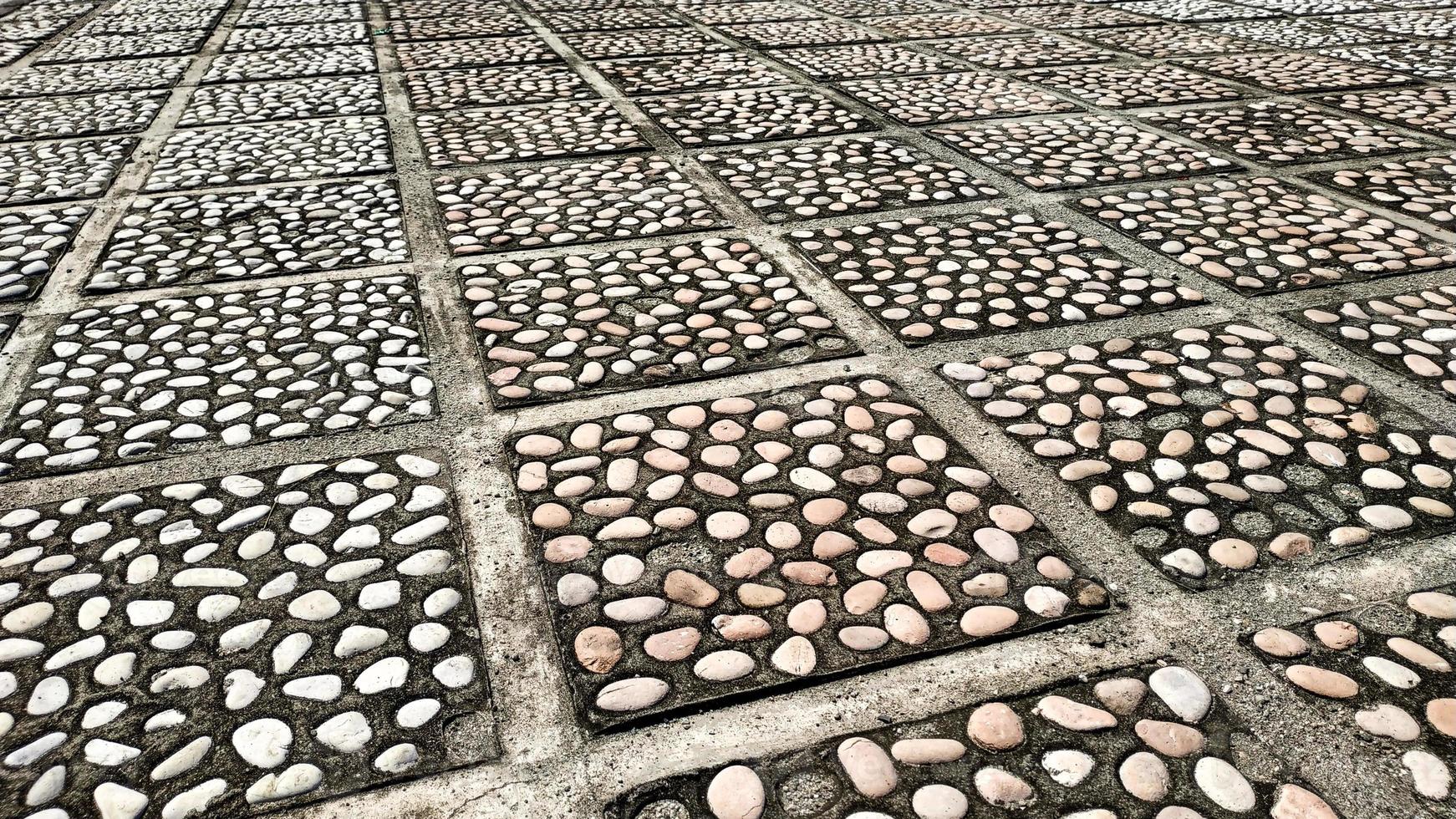 Floor motif of  natural stone paving blocks for your design concept.  Pattern background of floor. Paving block motif. Mosaic texture. photo