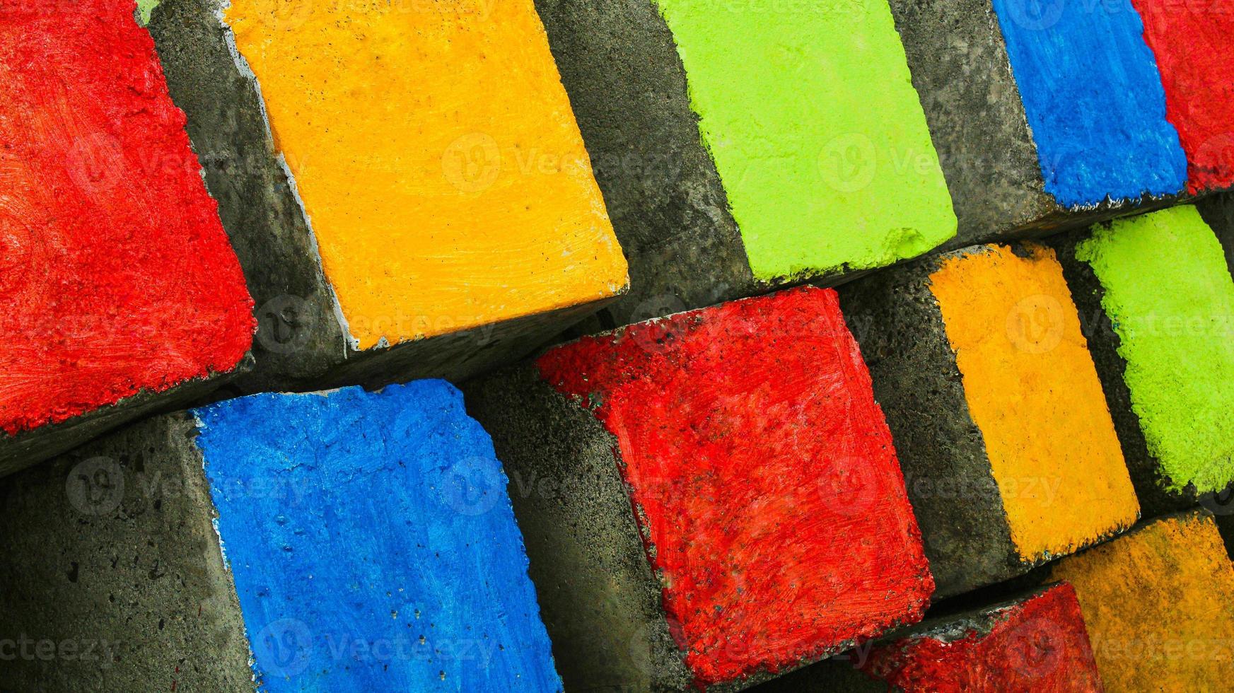 Close up from the side of embankment to block sea waves made of colorful cement blocks at Pasangkayu beach in Pasangkayu Regency, Indonesia. Colorful paving blocks. photo