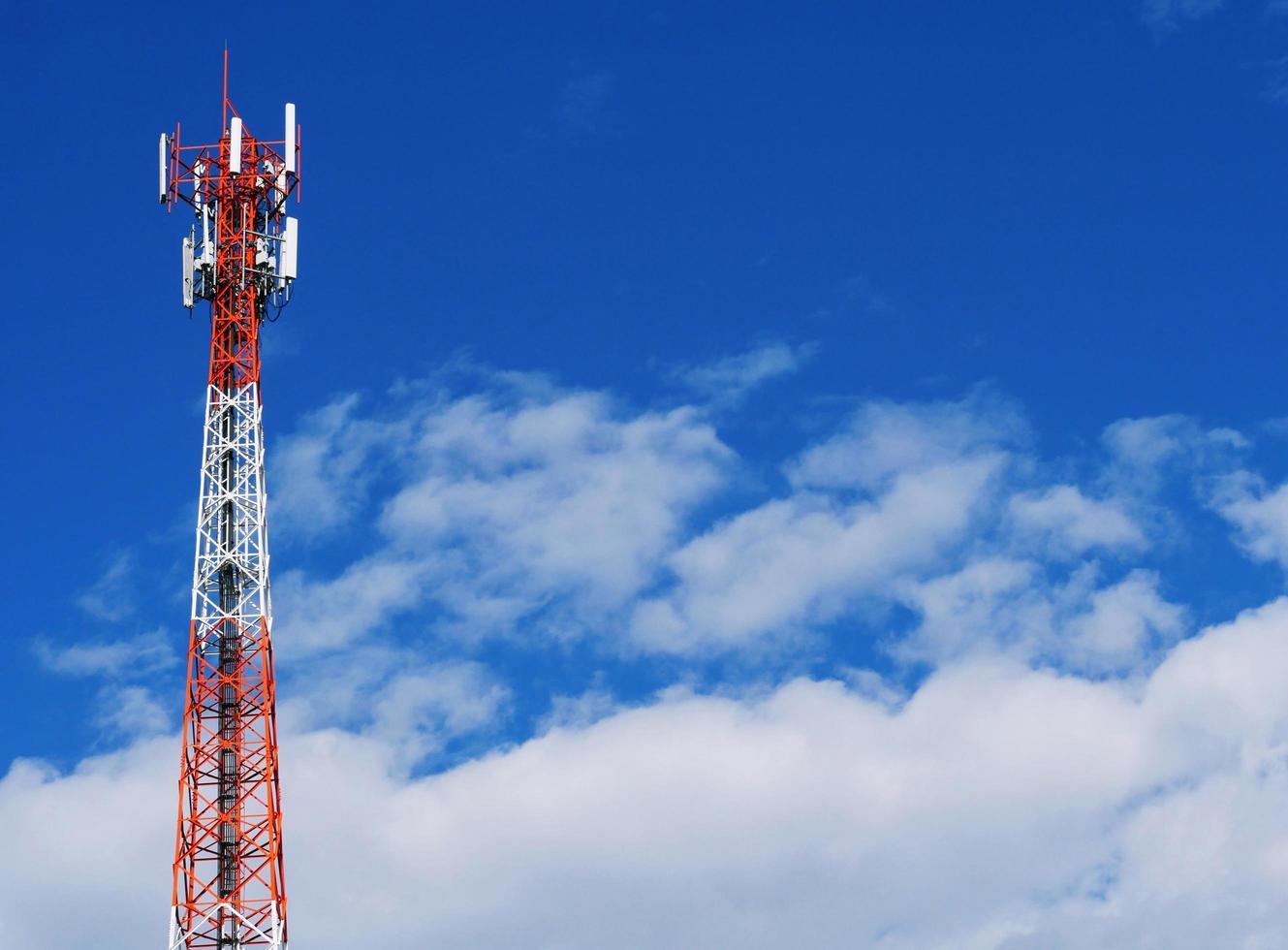 Telephone tower with white clouds in the background. photo