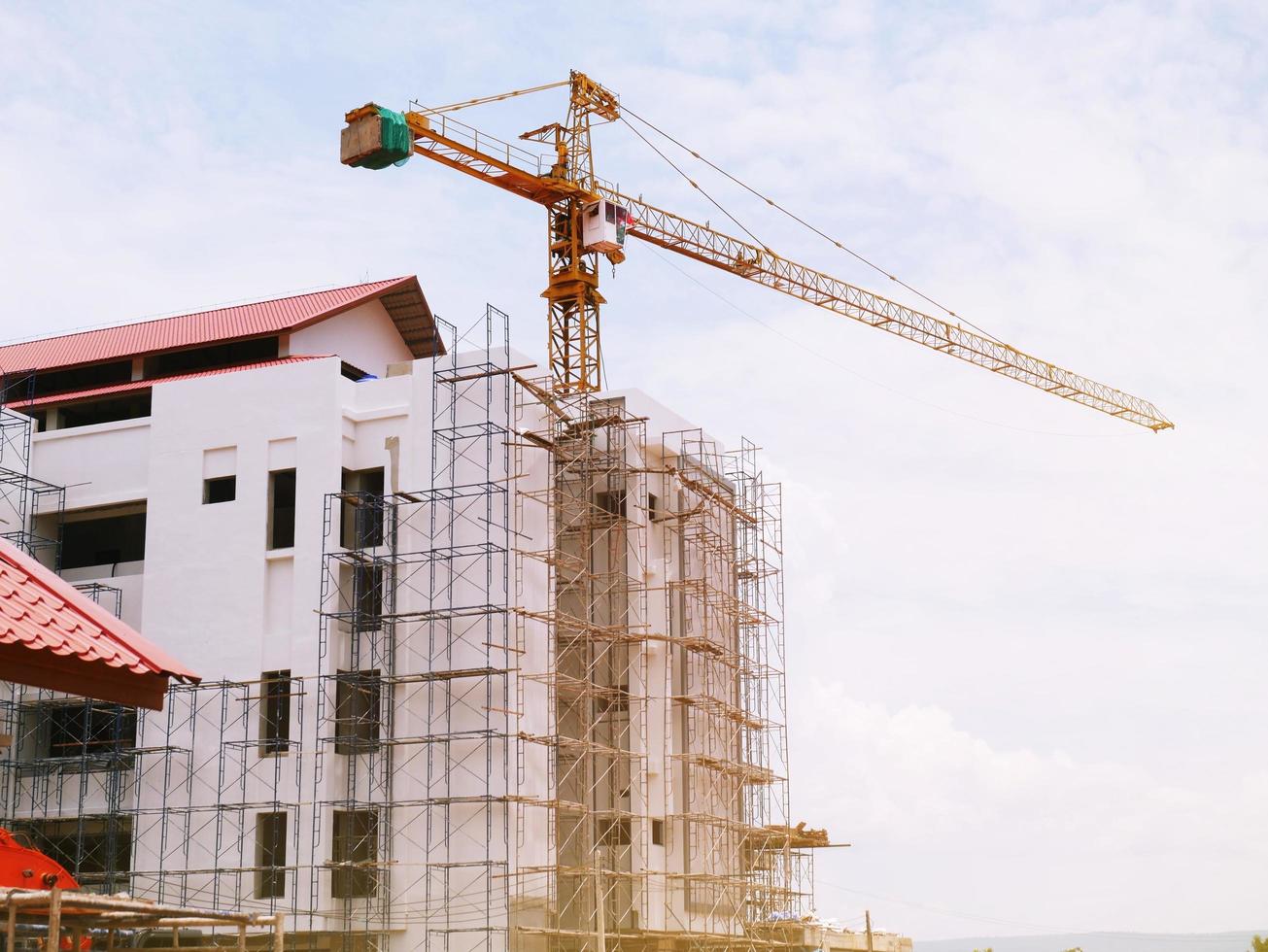 The building under construction overlooking the sky and clouds. photo