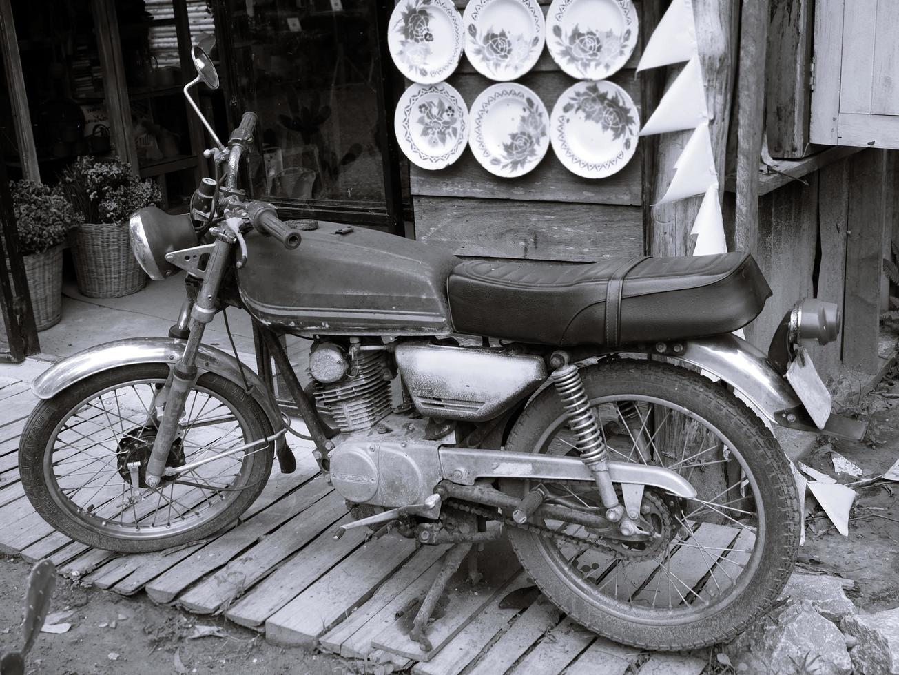 An old motorcycle parked in vintage style. photo