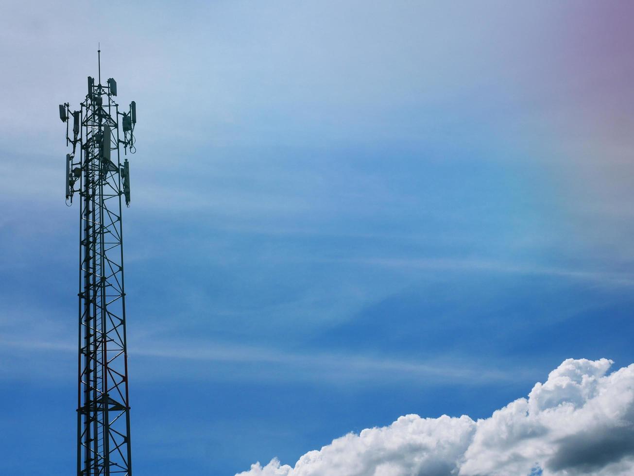 Telephone tower with white clouds in the background. photo