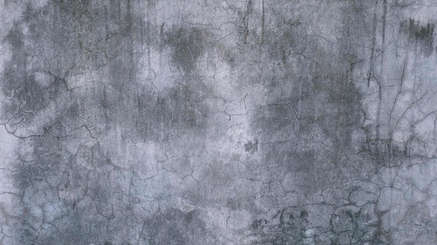 The old cement wall was weathered, the surface was scratched, the surface was scratched and damaged. For a mysterious retro-conservative background. photo