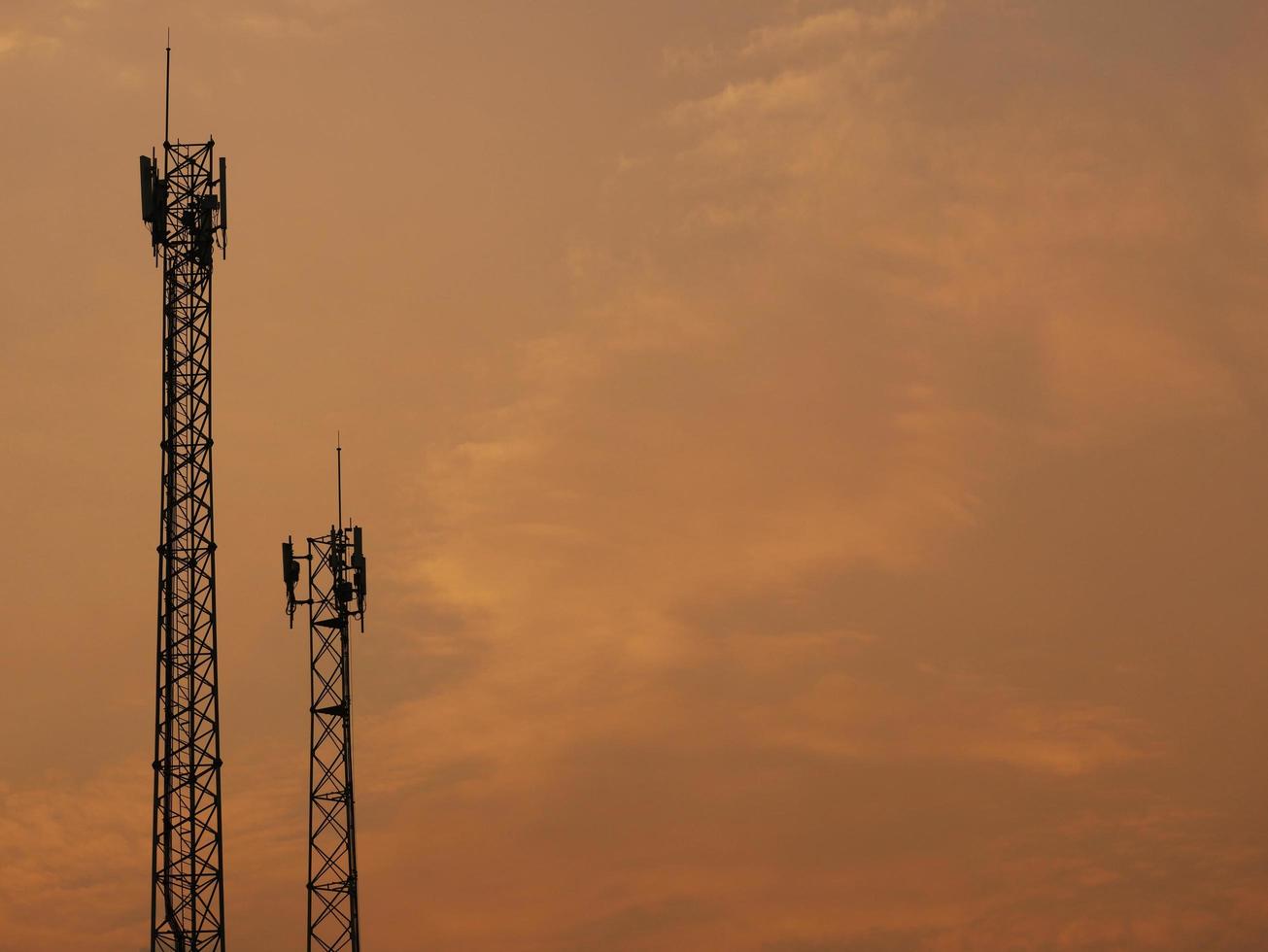 Two Telecom cell phone or telecommunication masts with blue sky backdrop, telecom tower for background uses. photo