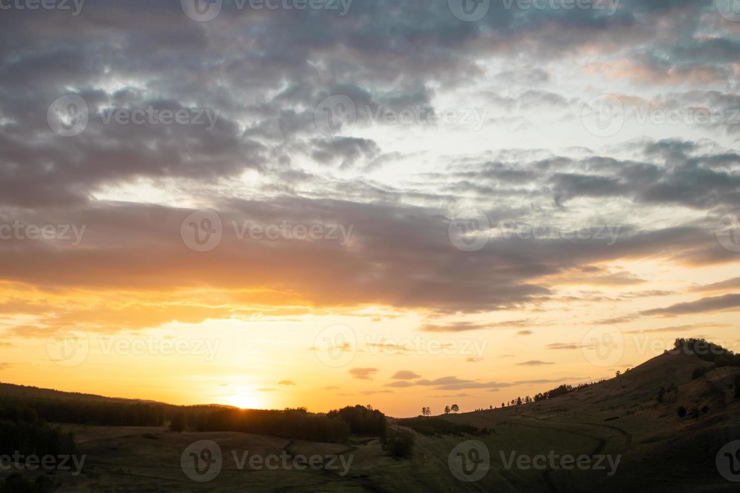 Colorful sunset on the background of mountains with beautiful clouds photo