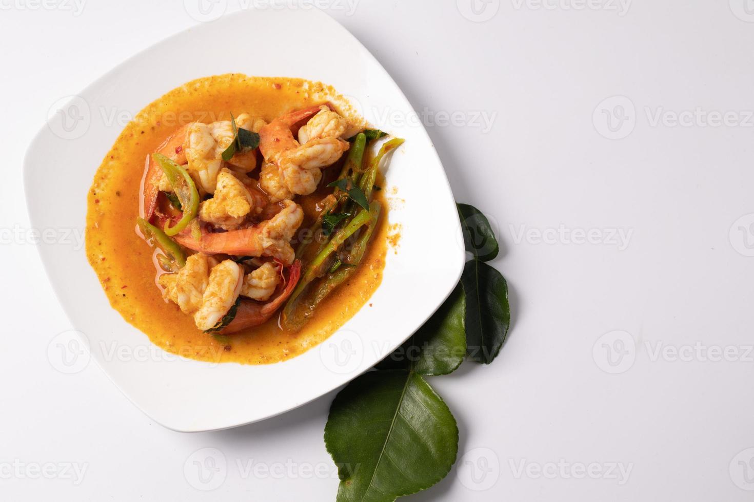 Stir fried shrimp with curry paste in a white plate. photo