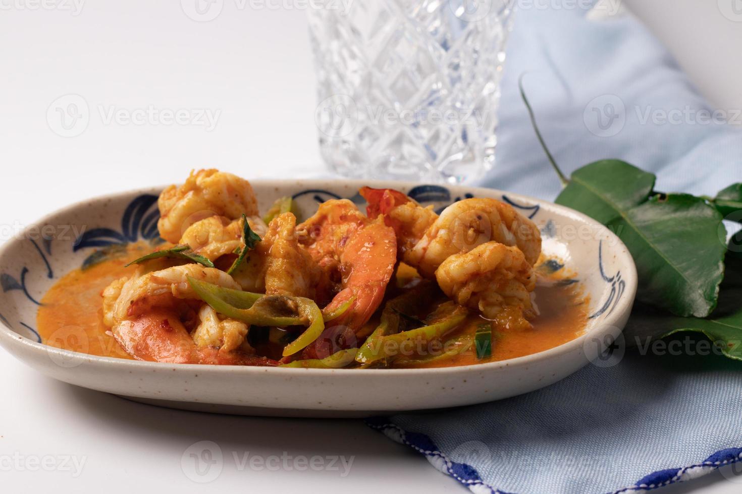 Stir fried shrimp with curry paste in a white plate. photo
