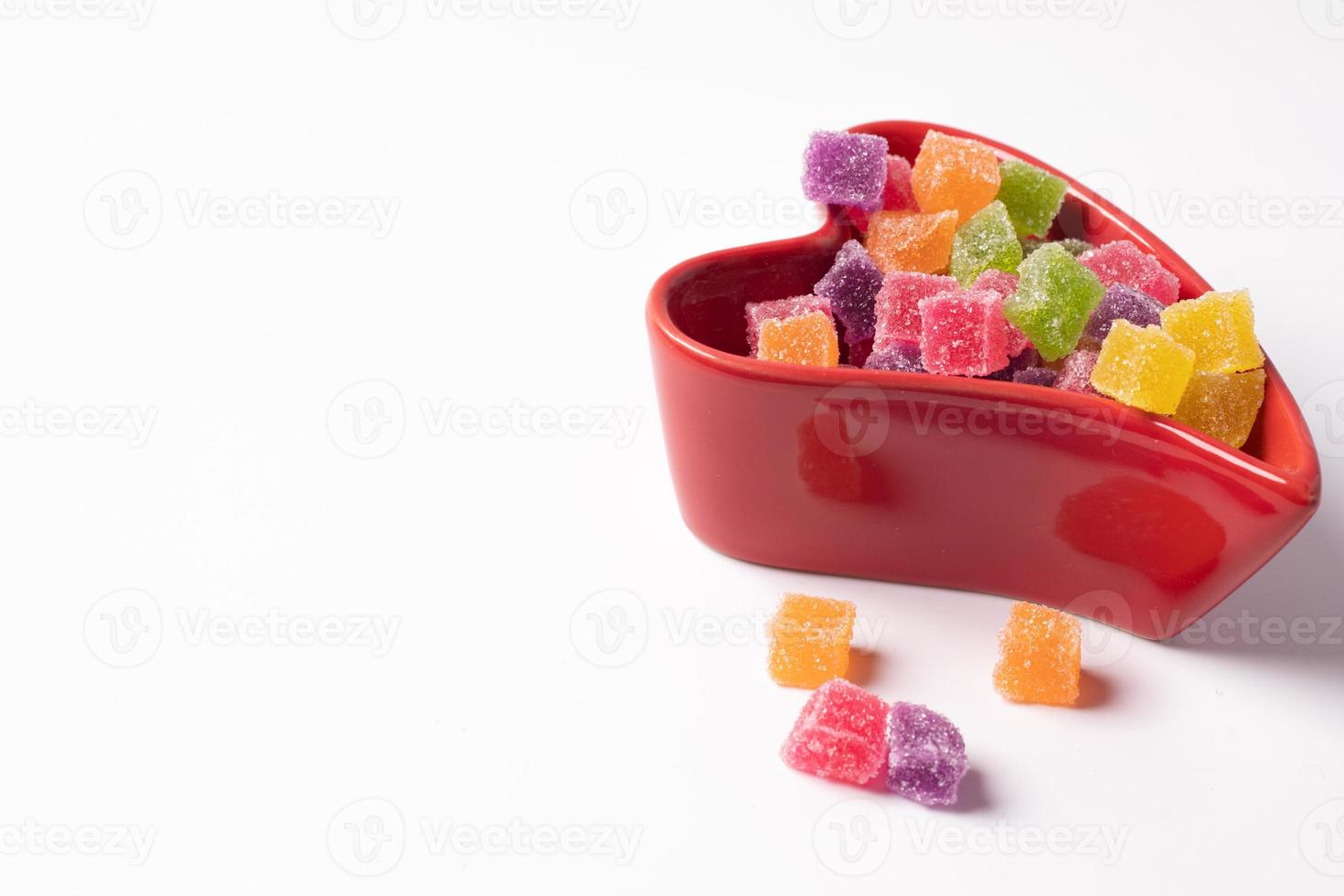 Colorful jelly in a red heart shaped cup. On a white background photo