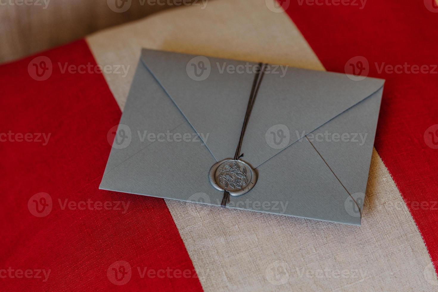 This envelope is for you. Wedding invitation card lies on red and white background. Decoration. Invitation concept. Correspondence photo