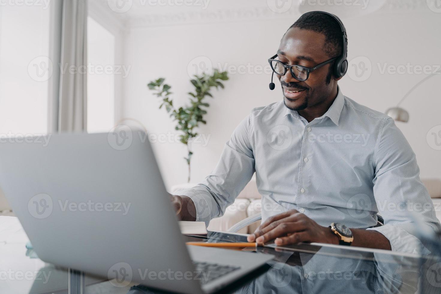 Manager of client support service has conversation. Afro american guy speaking in front of camera. photo