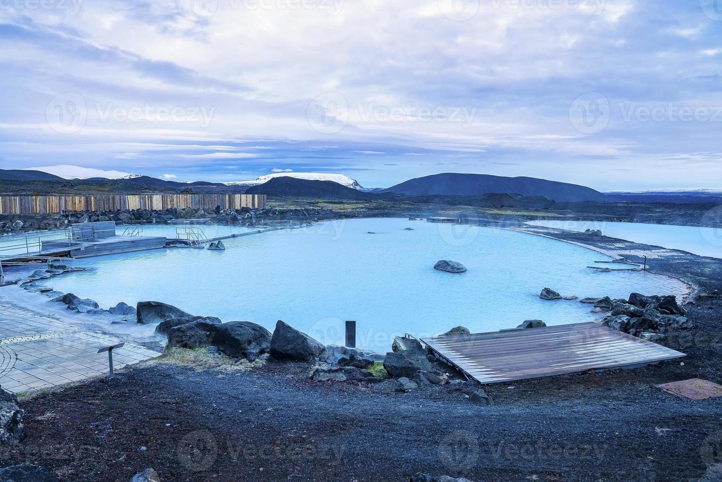 Beautiful view of natural blue lagoon in geothermal spa against cloudscape photo