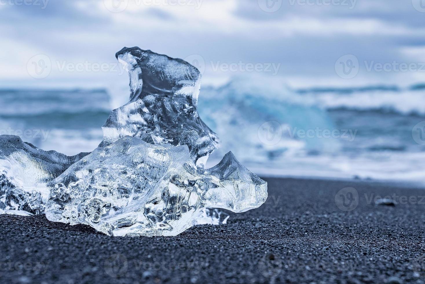 Close-up of beautiful iceberg chunk on shore of black sand at Diamond beach photo