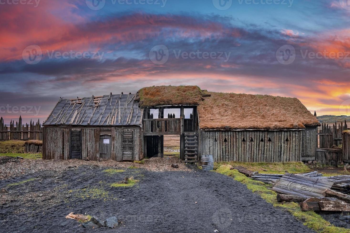 Traditional wooden house in Viking village against dramatic sky during sunset photo