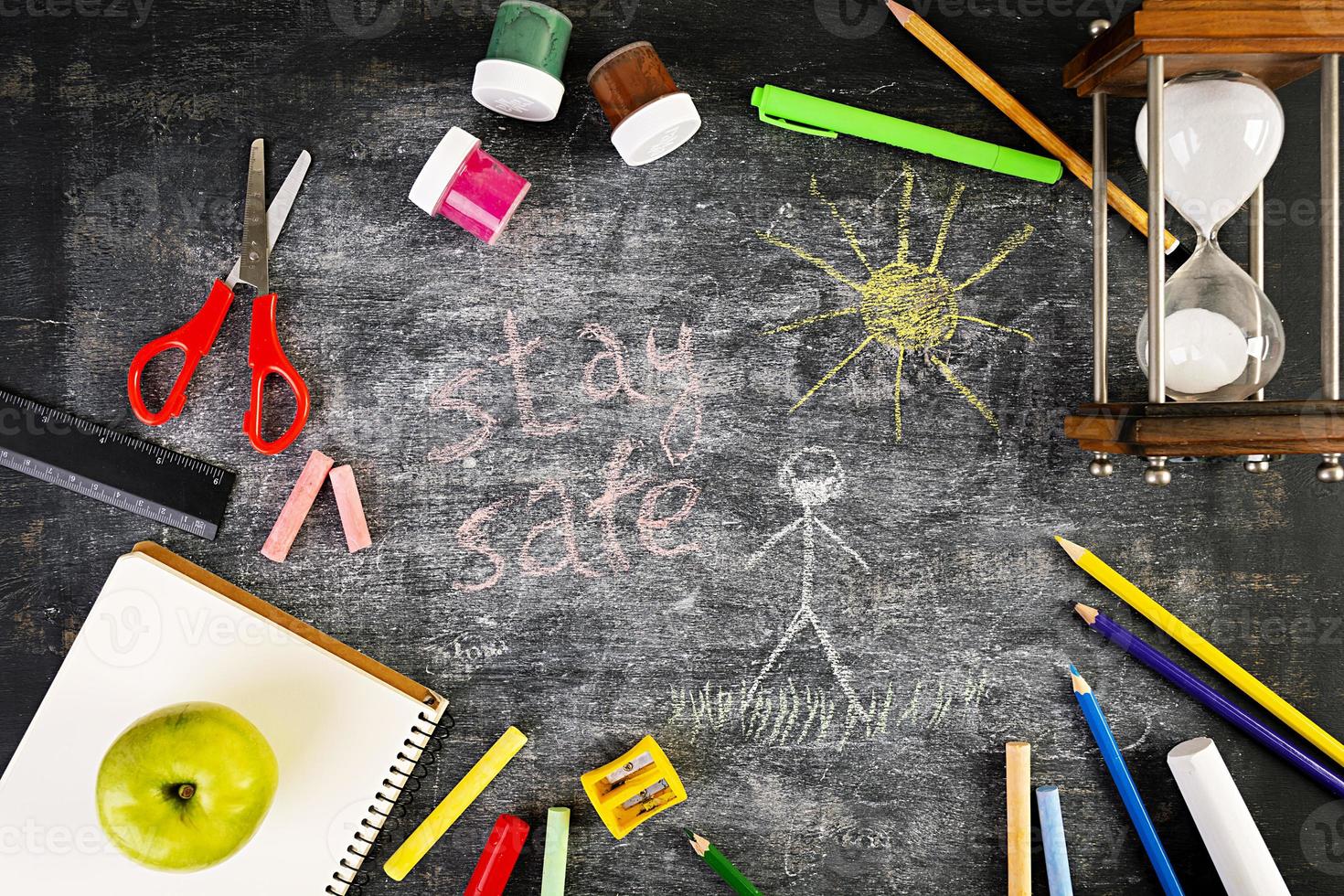 Background of dirty chalkboard. School concept with stationery supplies. Concept of self-isolation in an epidemic and pandemic photo