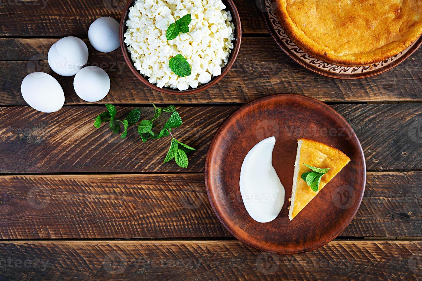 Homemade cottage cheese casserole on rustic wooden background. Top view photo