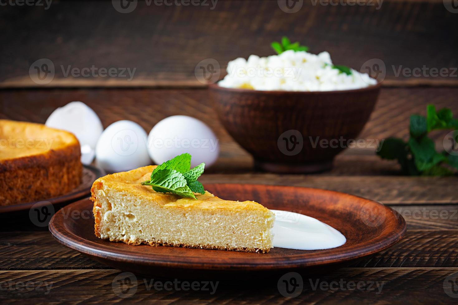 Homemade cottage cheese casserole on rustic wooden background photo