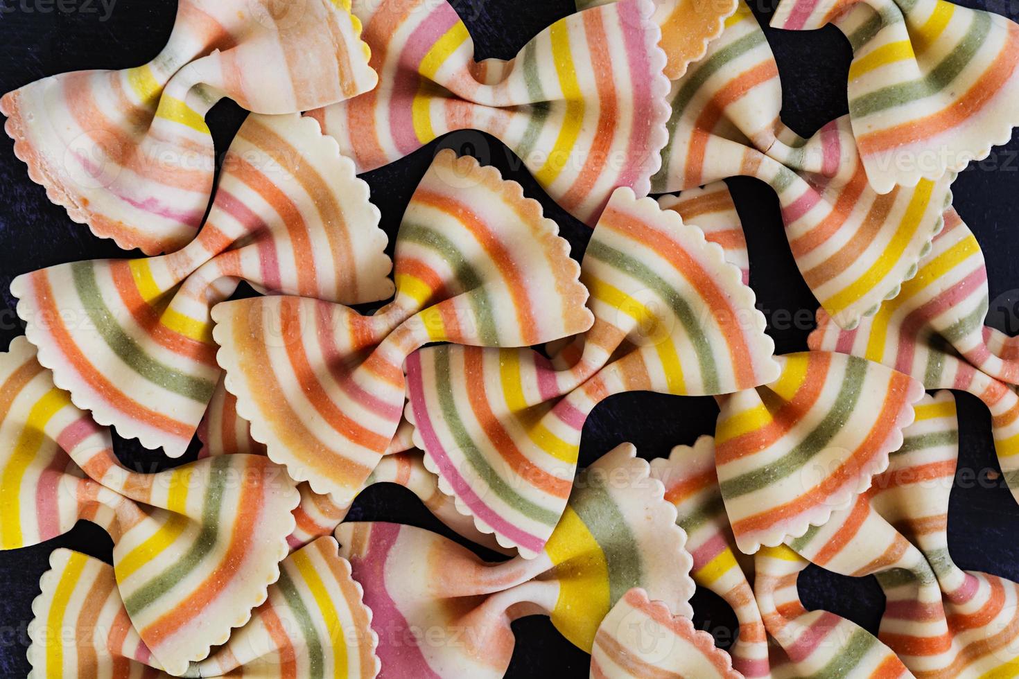 Mixed colorful farfalle pasta. Flat lay. Top view. photo