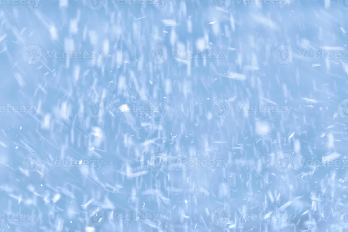 falling snow on a blue background photo