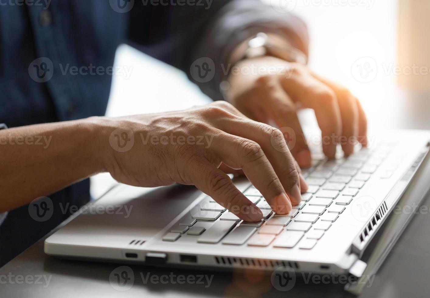 Man hand working on the laptop in office photo