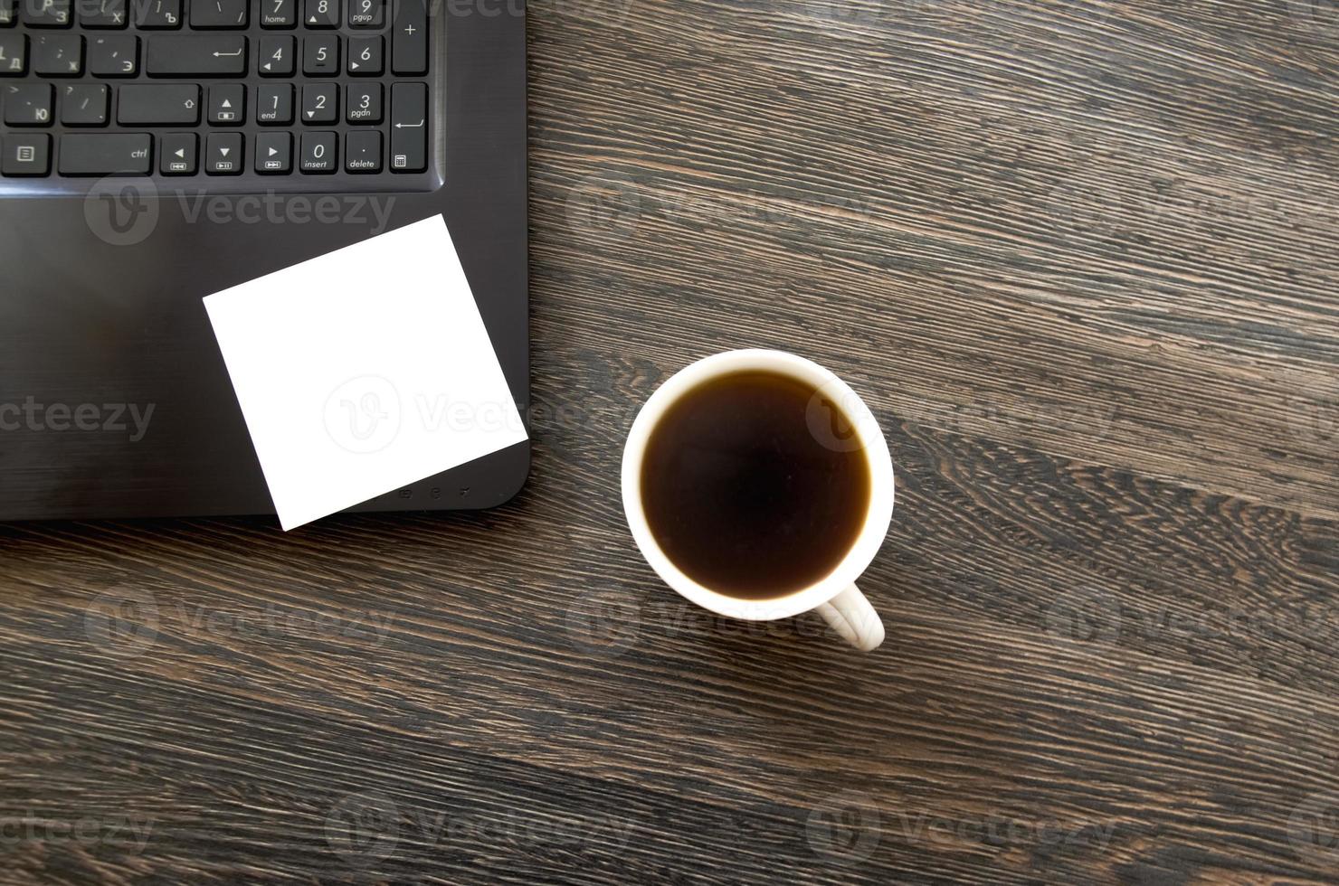 view from the top on a cup of coffee with a blank sheet for recording photo