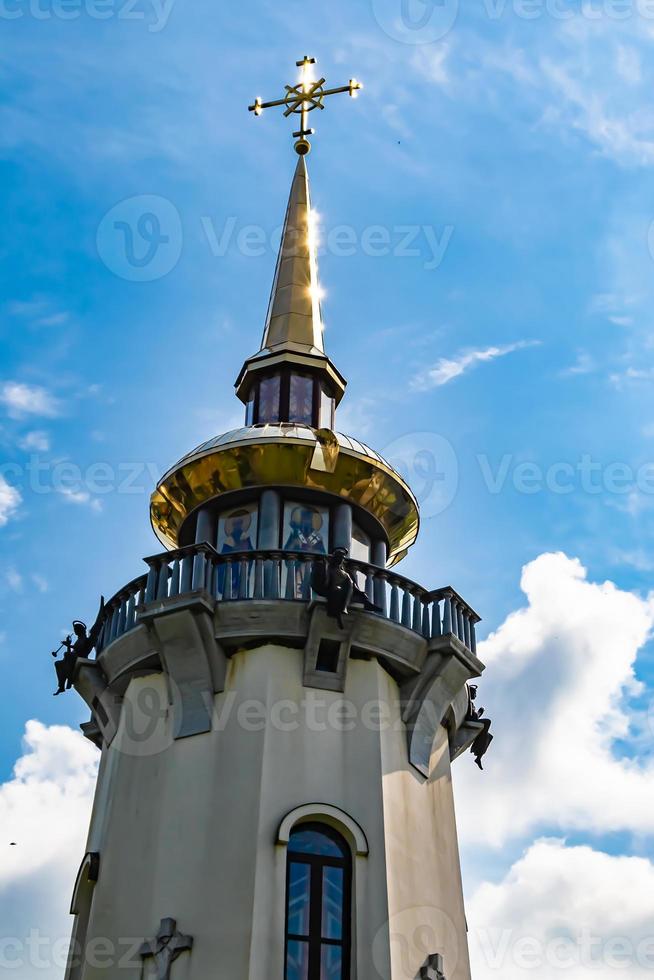 Christian church cross in high steeple tower for prayer photo